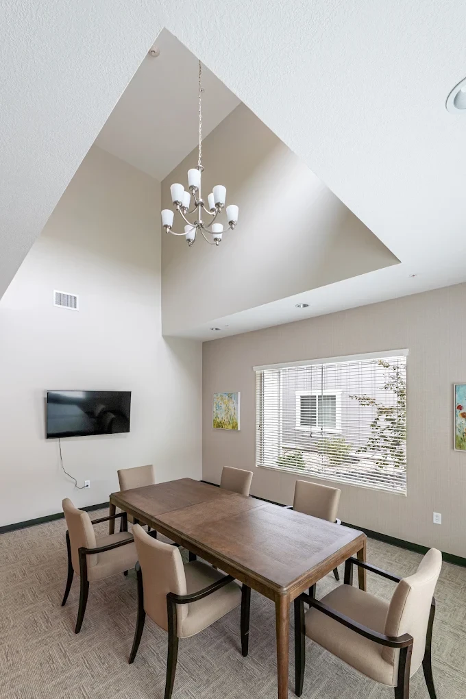A private family dining room with a vaulted ceiling and large window